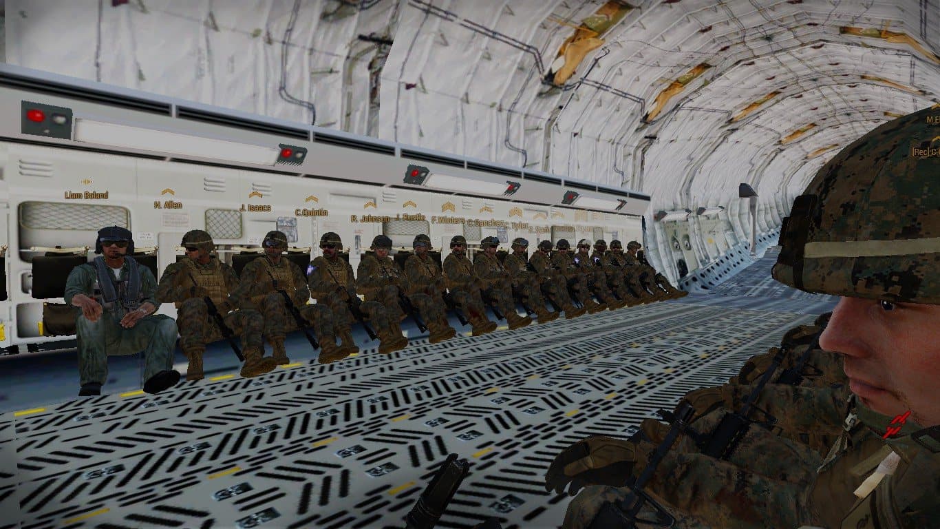 Marines seated down the cargo bay of a strategic airlifter