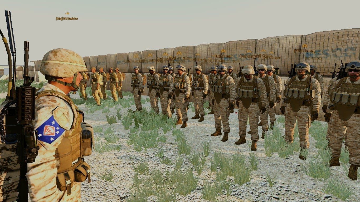 A Major inspecting a formation of Marines at a desert firebase, 2017